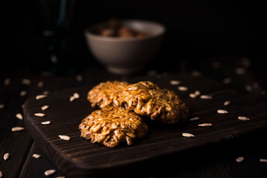 The 3-Ingredient Dog Treat That Changed Everything. A close-up of golden peanut butter pumpkin cookies on a rustic wooden table. Alt Text: There is a newly cooked dog treat with a peanut butter pumpkin on a wooden background, which is best utilised in a fast homemade recipe